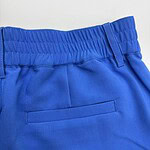 Close-up of bright blue casual pants with elastic waistband and back pocket, suitable for everyday wear and sports activities.