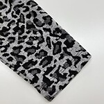 Close-up of leopard print fabric with black and gray pattern, suitable for clothing and accessories.