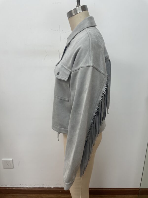 Elegant grey fringe jacket with shoulder flap and front pocket, perfect for casual or trendy outfits, displayed on a mannequin.