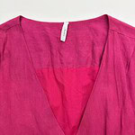 Bright pink linen blouse with V-neck design, perfect for casual or formal wear, displayed on a white background.