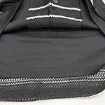 Close-up of a stylish black and white striped jacket with zipper details, perfect for casual or formal wear.