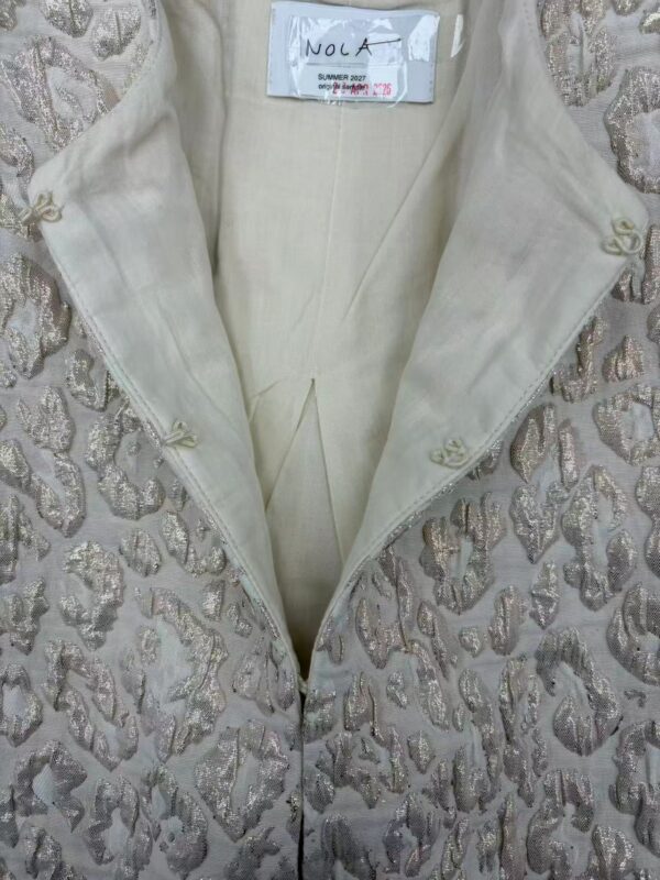 Close-up of a luxurious summer jacket with intricate embroidery and a soft, light fabric, perfect for stylish summer wear.