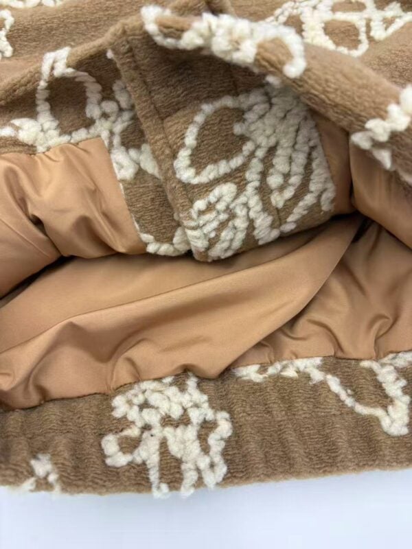 Close-up of a plush brown fleece blanket with cream floral patterns and satin lining, perfect for winter warmth and home decor.
