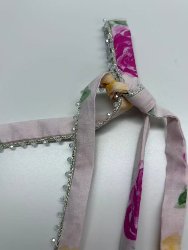 Beautiful floral satin headband with pearl and rhinestone embellishments, perfect for special occasions or fashion accessories.