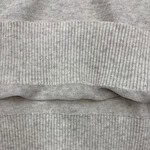 Close-up image of grey ribbed fabric, showcasing the texture and pattern of the material, ideal for fashion and clothing design.