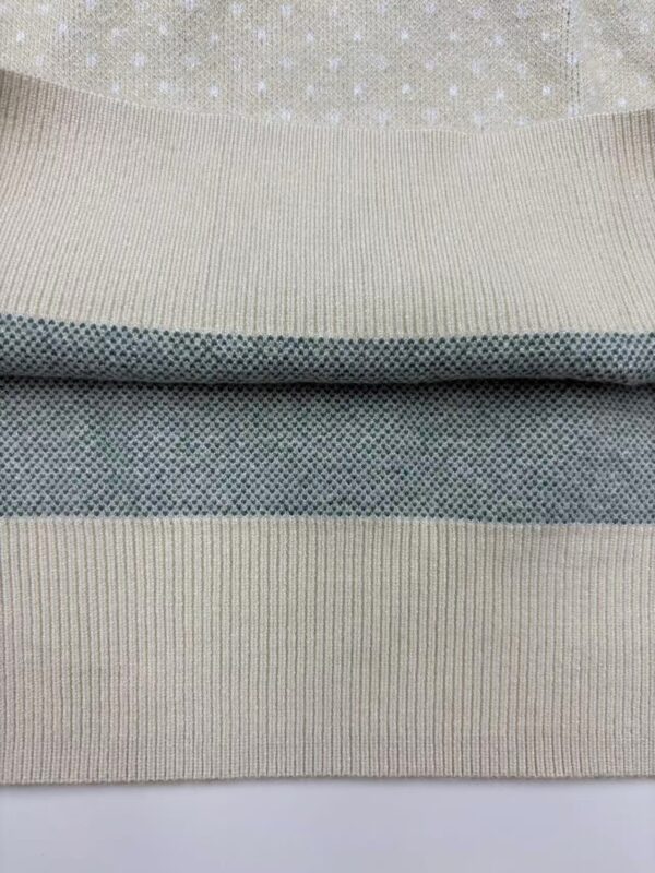 Detailed close-up of fabric textures showing different knit patterns and colors, highlighting quality textile craftsmanship.