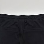 Close-up of black casual pants with elastic waistband and rear pockets, suitable for everyday wear and fashion.