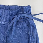Close-up of blue lounge pants with floral pattern and adjustable drawstring waist, perfect for casual wear and comfort.