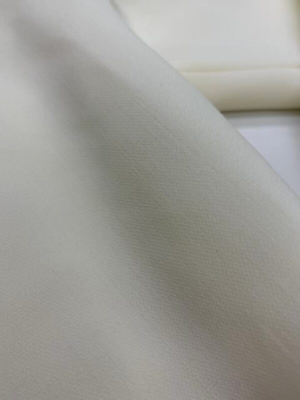 Close-up of smooth, high-quality white fabric suitable for fashion and apparel projects.