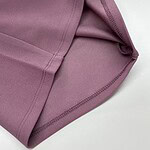 Close-up of pink sports leggings showing smooth fabric and stitched seams, ideal for activewear and fitness enthusiasts.