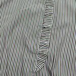 Close-up of striped fabric with ruffle detail, showcasing fine stitching and pattern, ideal for fashion and clothing design.