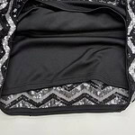 Close-up of a makeup bag with black fabric interior and sequined exterior, showcasing a stylish and functional accessory for cosmetics storage.