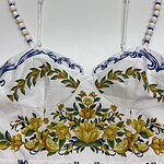Colorful embroidered dress with floral patterns and beaded straps, showcasing traditional craftsmanship and vibrant design.