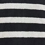 Close-up of black and white striped knit fabric, showcasing the texture and pattern of the material.