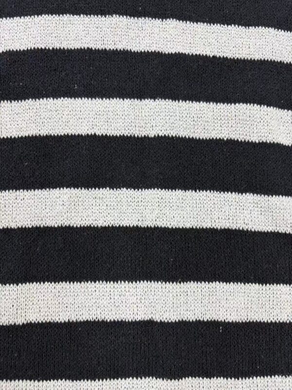 Close-up of black and white striped knit fabric, showcasing the texture and pattern of the material.