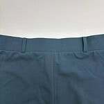 Close-up image of blue formal pants showing waistband and fabric texture for fashion and clothing SEO.