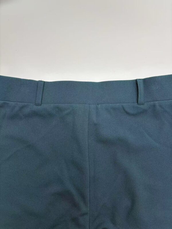 Close-up image of blue formal pants showing waistband and fabric texture for fashion and clothing SEO.