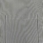 Close-up of a black and white vertically striped shirt with a single chest pocket.
