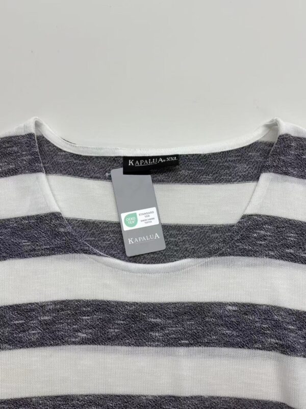 Close-up of a gray and white striped T-shirt with a Kapalua tag, suitable for casual fashion and everyday wear.