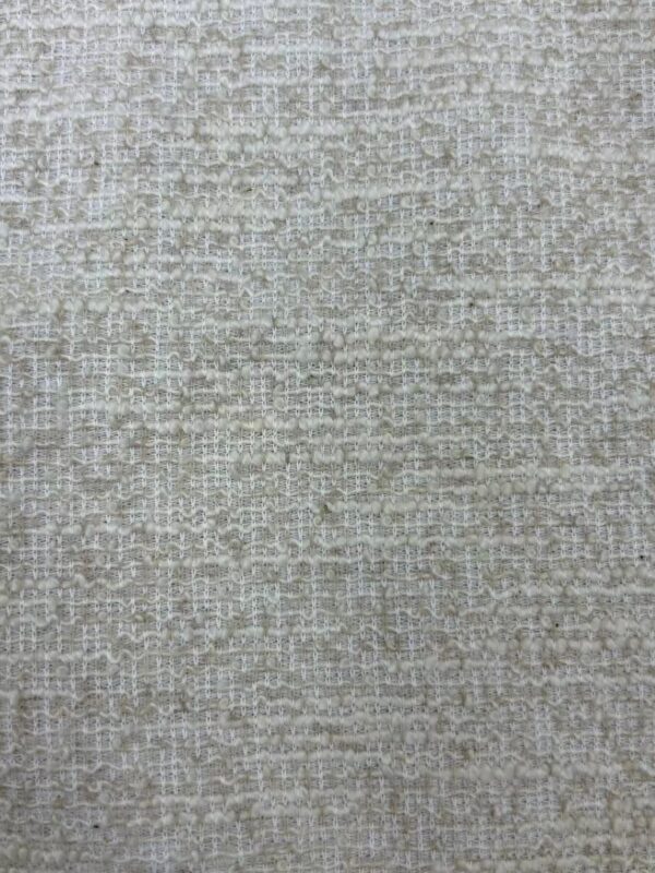Close-up of beige textured fabric with a subtle woven pattern, ideal for fashion and upholstery projects.