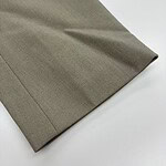 Close-up of khaki fabric with a smooth texture, suitable for clothing and fashion accessories.