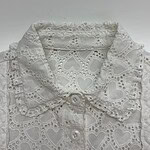 White eyelet lace blouse with heart-shaped patterns and scalloped edges, featuring a collar and button-down front, perfect for stylish casual wear.