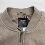 Close-up of a beige Chicoree outerwear jacket with a zipper and collar, size L, suitable for casual and stylish winter wear.