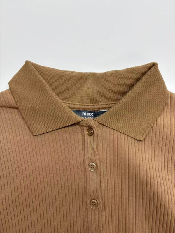 Close-up of a men's ribbed polo shirt in tan color with a classic collar and button placket, perfect for casual or smart-casual outfits.