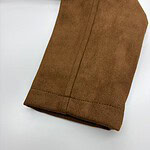 Close-up of brown suede fabric with visible stitching, highlighting texture and quality for fashion or upholstery use.