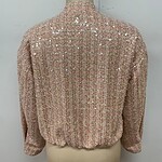Pink sequin blouse with long sleeves and high neckline, perfect for special occasions or evening wear.