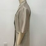 Stylish beige women's coat displayed on a mannequin, perfect for fall fashion, featuring a tailored fit and knee-length design.