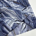Close-up of blue plaid fabric with various shades of blue, gray, and brown, showcasing a soft, lightweight material suitable for clothing or accessories.