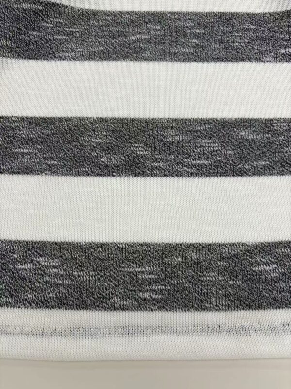 Close-up of black and white striped fabric, showcasing texture and pattern suitable for fashion design and clothing.
