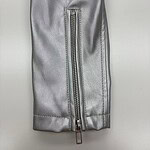 Close-up of a silver leather jacket sleeve featuring a vertical zipper, showcasing high-quality material and craftsmanship.