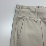Close-up of beige men's dress pants showing waistband, belt loops, and front pocket details for a sophisticated look.