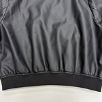Stylish black leather bomber jacket with ribbed cuffs and waistband, perfect for casual and streetwear fashion.