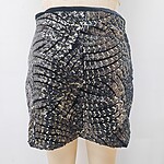 Shimmering black and gold sequin mini skirt with intricate pattern, perfect for parties and special occasions.