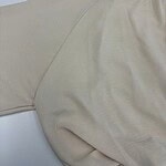 Close-up of a beige casual polo shirt made from soft fabric, featuring a collar and short sleeves, suitable for everyday wear.