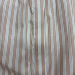 Close-up of beige and white vertical striped fabric, showing texture and stitching details.