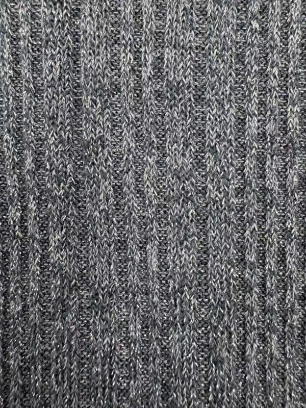 Close-up of a textured gray and black knitted fabric, showcasing intricate pattern and fine craftsmanship, ideal for stylish clothing and accessories.