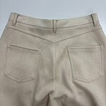 Close-up of beige casual pants with back pockets, suitable for everyday wear and fashion styling.