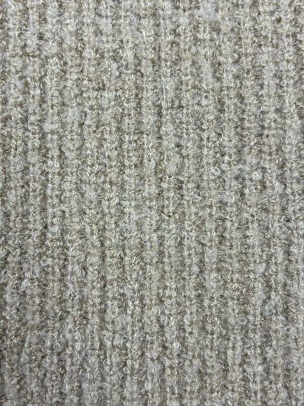 Close-up of a beige textured carpet with a loop pile pattern, ideal for modern home or office decor.