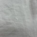 Close-up of plain white fabric background, suitable for fashion and clothing product displays.