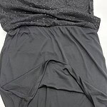 Close-up of a black athletic skirt made from lightweight, breathable fabric, designed for sports or casual wear, with a comfortable elastic waistband.